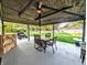 Spacious outdoor patio with a wooden ceiling, fan, dining set, and a view of the backyard at 10751 N Kitchen Rd, Mooresville, IN 46158