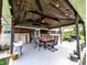 Covered patio area with rustic wood ceiling, string lights, and outdoor dining set at 10751 N Kitchen Rd, Mooresville, IN 46158