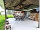 Inviting patio with a wooden ceiling, dining area, and view of the well-manicured lawn at 10751 N Kitchen Rd, Mooresville, IN 46158