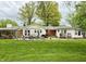 Backyard with a well-manicured lawn and a variety of patio furniture at 10946 Maze Rd, Indianapolis, IN 46259