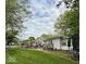 Well maintained backyard featuring an above ground pool, patio with seating, and a charming white house with a deck at 10946 Maze Rd, Indianapolis, IN 46259