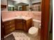 Bathroom featuring a sink, toilet, and pink tile at 10946 Maze Rd, Indianapolis, IN 46259