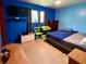 Bright blue bedroom featuring a bed, TV, and window with natural light at 10946 Maze Rd, Indianapolis, IN 46259