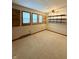 A bedroom featuring carpeting, a ceiling fan, three windows, floating shelves, and electrical outlets at 10946 Maze Rd, Indianapolis, IN 46259