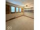 A bedroom featuring carpeting, a ceiling fan, three windows, floating shelves, and electrical outlets at 10946 Maze Rd, Indianapolis, IN 46259