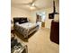 Cozy bedroom with ceiling fan, bed with patterned quilt, and adjoining room at 10946 Maze Rd, Indianapolis, IN 46259