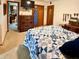 Bedroom showcasing a bed with blue and white quilt and an oak dresser at 10946 Maze Rd, Indianapolis, IN 46259
