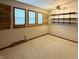 Empty bedroom with three windows and wood trim, plus industrial shelves at 10946 Maze Rd, Indianapolis, IN 46259