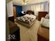 Cozy bedroom with patterned bedding, wooden headboard, and ample natural light at 10946 Maze Rd, Indianapolis, IN 46259