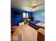 Bright blue bedroom featuring a bed, furniture, TV, and sunny window with view to the outdoors at 10946 Maze Rd, Indianapolis, IN 46259