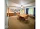 Bright dining area boasts a wooden table set, Gathering photo decor, and natural light from the window at 10946 Maze Rd, Indianapolis, IN 46259