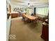 Inviting dining area with a large wooden table, carpet flooring, and unique wall decor at 10946 Maze Rd, Indianapolis, IN 46259