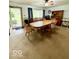 Cozy dining area with a wooden table set, carpet flooring, and vintage-style décor at 10946 Maze Rd, Indianapolis, IN 46259