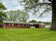 Charming brick ranch home with a large front yard and mature trees at 10946 Maze Rd, Indianapolis, IN 46259