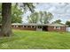 Charming single-story home featuring a well-maintained lawn and traditional brick exterior at 10946 Maze Rd, Indianapolis, IN 46259