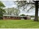 Charming single-story home featuring a well-maintained lawn and traditional brick exterior at 10946 Maze Rd, Indianapolis, IN 46259