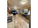 Open floor plan features kitchen with modern appliances flowing into the adjoining Gathering entertainment space at 10946 Maze Rd, Indianapolis, IN 46259