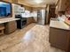 Spacious kitchen with modern stainless steel appliances, countertops and warm-toned cabinetry at 10946 Maze Rd, Indianapolis, IN 46259
