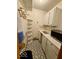Compact kitchen offering a microwave, white cabinets, and black and white tiled flooring at 10946 Maze Rd, Indianapolis, IN 46259
