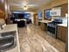 Spacious kitchen view showing open floorplan leading to living area and stainless appliances at 10946 Maze Rd, Indianapolis, IN 46259