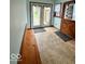 Mud room features a built-in bench, door to the back yard, and wood flooring at 10946 Maze Rd, Indianapolis, IN 46259
