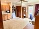 Office area with built-in desk, shelving, closet, and door leading to backyard at 10946 Maze Rd, Indianapolis, IN 46259