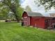 Red shed with white trim in a fenced-in backyard at 10946 Maze Rd, Indianapolis, IN 46259