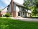 Back exterior view showcasing a spacious yard, patio, and architectural details of the home at 11021 Brentwood Ave, Zionsville, IN 46077