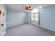 A light-filled bedroom with a large window, ceiling fan, and neutral carpeting at 1120 Crystal Ct, Avon, IN 46123