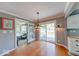 Cozy dining area with hardwood floors, slider door access to a screened-in porch, and stylish lighting at 1120 Crystal Ct, Avon, IN 46123