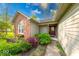 Inviting front entrance with brick accents, colorful landscaping, and a decorative front door at 1120 Crystal Ct, Avon, IN 46123