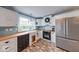 Updated kitchen featuring stainless steel appliances, butcher block counters, and brick floors at 1120 Crystal Ct, Avon, IN 46123