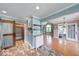 Open kitchen with brick floors, wooden shelves, and a barn door to the pantry at 1120 Crystal Ct, Avon, IN 46123