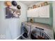 An organized laundry room featuring updated washer and dryer, upper cabinets and farmhouse decor at 1120 Crystal Ct, Avon, IN 46123