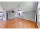 Open living room with hardwood floors, vaulted ceiling, and natural light from large windows at 1120 Crystal Ct, Avon, IN 46123
