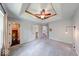 Spacious main bedroom with tray ceiling, ceiling fan, walk-in closet, and ensuite bathroom at 1120 Crystal Ct, Avon, IN 46123
