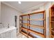 A bright pantry area with wooden shelves, a utility sink and under cabinet storage at 1120 Crystal Ct, Avon, IN 46123