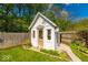 Charming shed in a backyard garden with a beautifully landscaped yard and picket fence at 1120 Crystal Ct, Avon, IN 46123