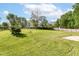Large backyard with a well-maintained lawn and mature trees, offering ample space at 11603 Peacock Dr, Indianapolis, IN 46236