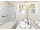 Well-lit bathroom with a white sink, toilet, and a combined shower and bathtub at 11603 Peacock Dr, Indianapolis, IN 46236