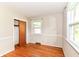 Bright bedroom featuring hardwood floors, large windows, and neutral paint at 11603 Peacock Dr, Indianapolis, IN 46236