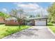 Charming brick ranch-style home with attached garage and mature landscaping at 11603 Peacock Dr, Indianapolis, IN 46236