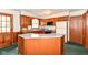 Kitchen with wood cabinets, a center island, and modern appliances at 11603 Peacock Dr, Indianapolis, IN 46236