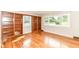 Bright living room with hardwood floors, built-in bookcases, and large windows at 11603 Peacock Dr, Indianapolis, IN 46236