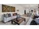 Open living room leading to the dining area and kitchen, featuring two sofas and a rustic coffee table at 11820 Vale St, Indianapolis, IN 46235