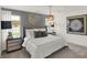 Beautiful bedroom featuring a stylish bed, decorative wall art, and elegant lighting fixtures at 11840 Vale St, Indianapolis, IN 46235