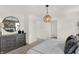 Bright bedroom featuring a decorative mirror, modern furniture, and doorway to a bathroom at 11840 Vale St, Indianapolis, IN 46235