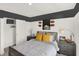 Stylish bedroom featuring sports decor, an open closet, and comfortable bedding at 11840 Vale St, Indianapolis, IN 46235