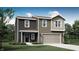 Two-story home featuring mixed siding, an attached garage, and neatly landscaped grounds at 11840 Vale St, Indianapolis, IN 46235
