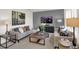 Tastefully decorated living room with modern furniture, stylish lamps, and a wall-mounted television at 11840 Vale St, Indianapolis, IN 46235
